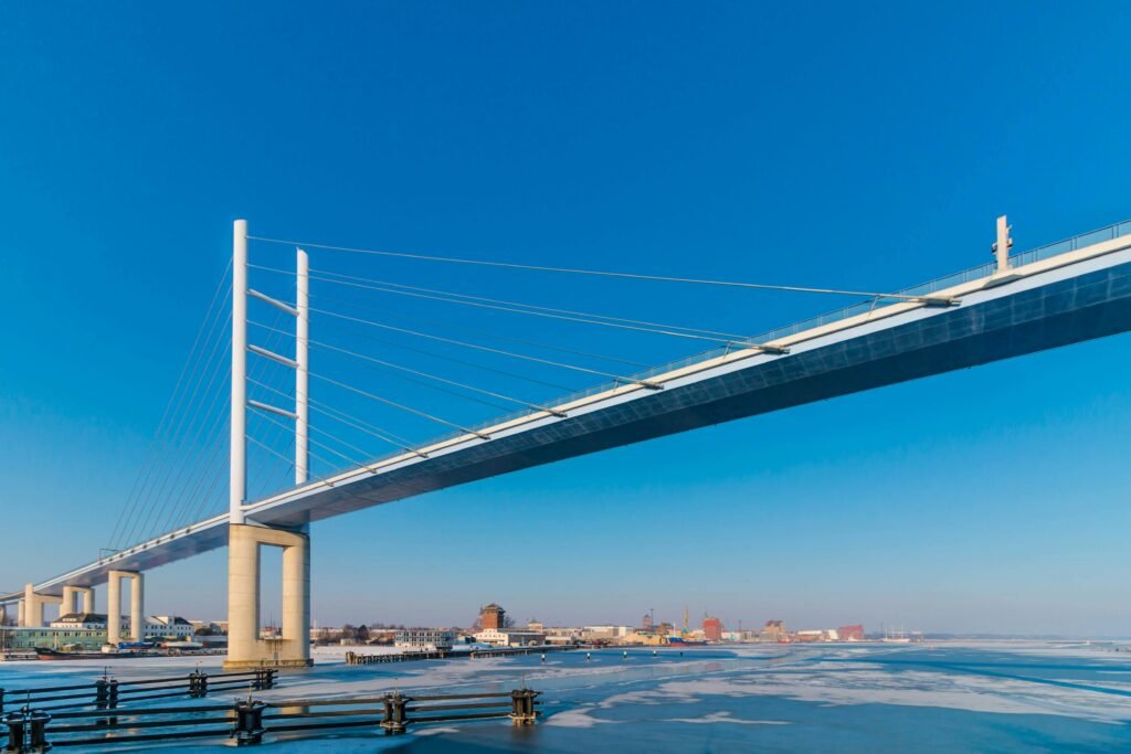 pexels-photo-915697-915697 Beautiful Rügen Bridge over frozen water on a clear winter day in Stralsund, Germany.